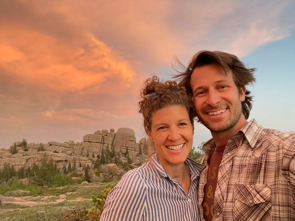 Nolan and Dimity, Morrow’s founders, smiling outdoors at sunset
